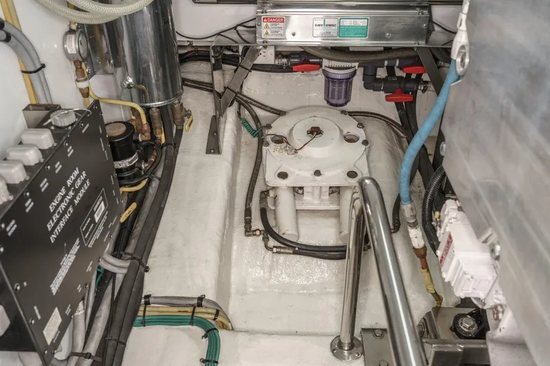 Slide: The Image of Engine room of 2006 Ocean Alexander 64 Pilothouse with mechanical components and wiring. - 77