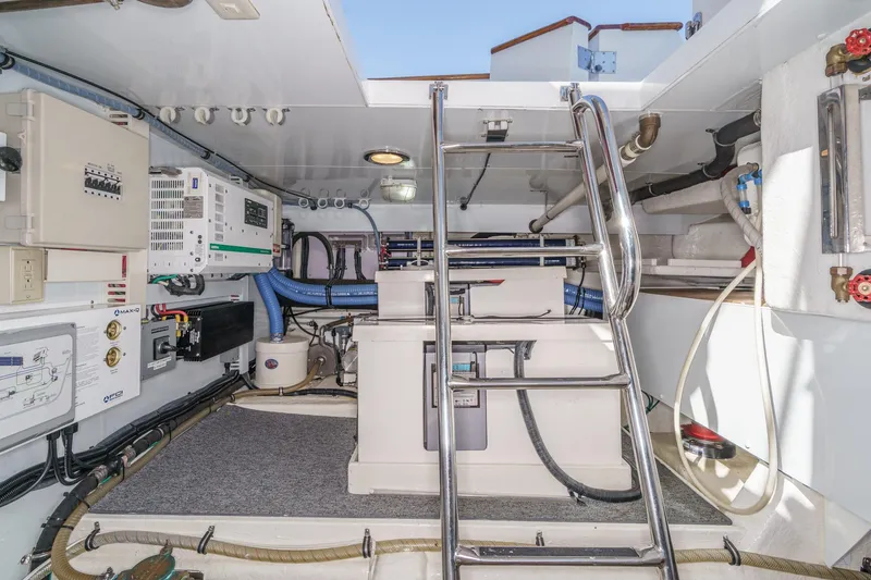 Slide: The Image of Engine room of 2006 Ocean Alexander 64 Pilothouse yacht with equipment and ladder. - 78