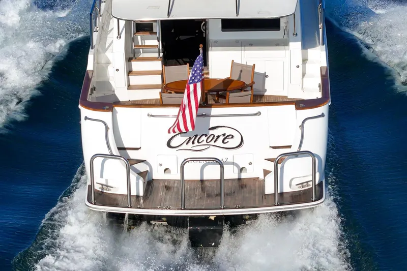 Slide: The Image of 2006 Ocean Alexander 64 Pilothouse yacht cruising with American flag displayed. - 79