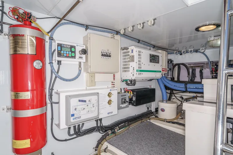 Slide: The Image of Engine room of 2006 Ocean Alexander 64 Pilothouse with fire extinguisher and control panels. - 80