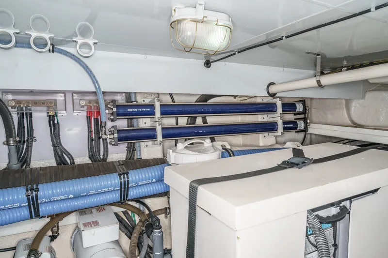 Slide: The Image of Engine room of 2006 Ocean Alexander 64 Pilothouse yacht with visible piping and equipment. - 81