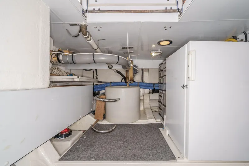 Slide: The Image of Engine room of 2006 Ocean Alexander 64 Pilothouse yacht, featuring pipes and storage. - 82