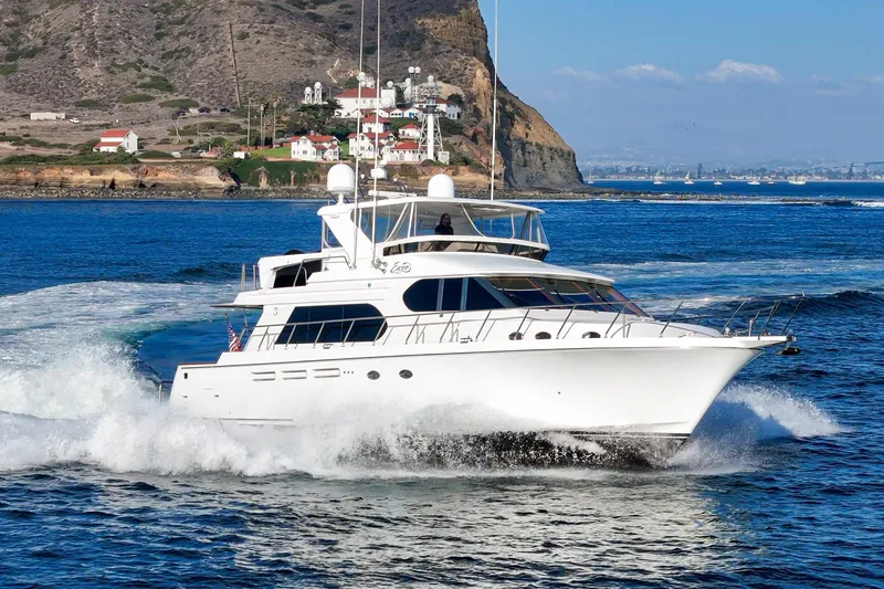 Slide: The Image of Luxury 2006 Ocean Alexander 64 Pilothouse yacht cruising near scenic coastline. - 9