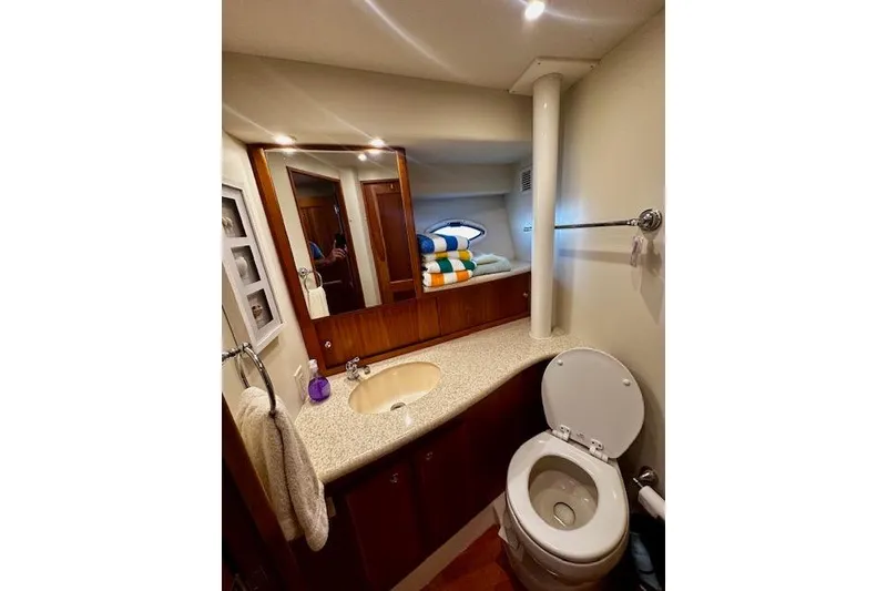 Slide: The Image of Bathroom interior of 2001 Silverton 42 Convertible yacht, featuring sink and toilet. - 11