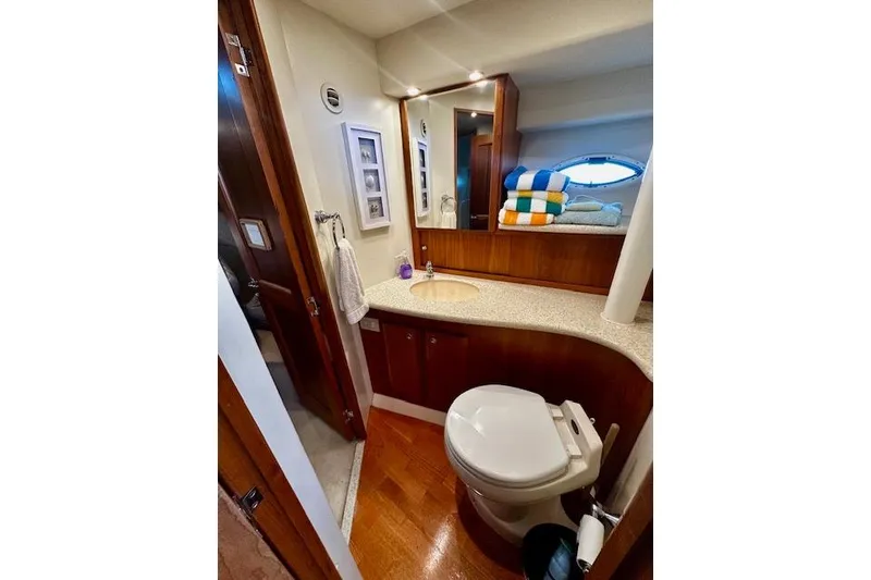 Slide: The Image of Luxurious bathroom in 2001 Silverton 42 Convertible yacht with modern amenities and elegant design. - 17