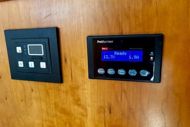 Slide: The Image of Control panel on 2001 Silverton 42 Convertible boat, displaying ProMariner charger settings. - 20