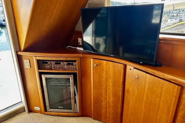 Slide: The Image of 2001 Silverton 42 Convertible yacht interior with TV and mini fridge. - 21