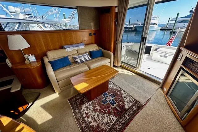 Slide: The Image of Luxurious 2001 Silverton 42 Convertible yacht interior with cozy seating and marina view. - 3