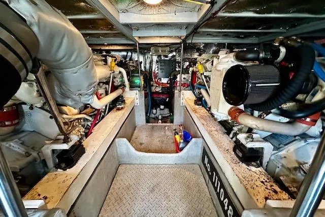 Slide: The Image of Engine room of a 2001 Silverton 42 Convertible yacht, showcasing dual engines and mechanical components. - 40