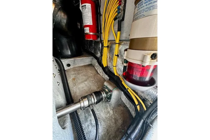 Slide: The Image of Engine room of 2001 Silverton 42 Convertible with wiring, fire extinguisher, and fuel filter. - 42