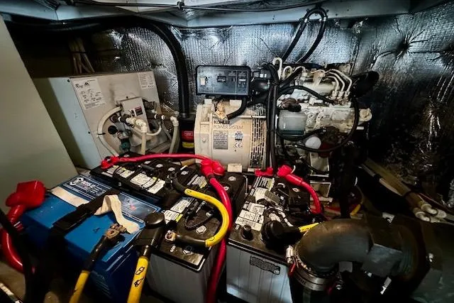 Slide: The Image of Engine room of 2001 Silverton 42 Convertible with batteries and generator. - 44