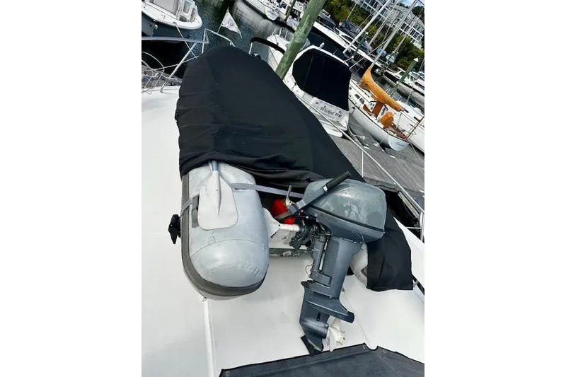 Slide: The Image of 2001 Silverton 42 Convertible with covered dinghy and outboard motor on deck. - 45