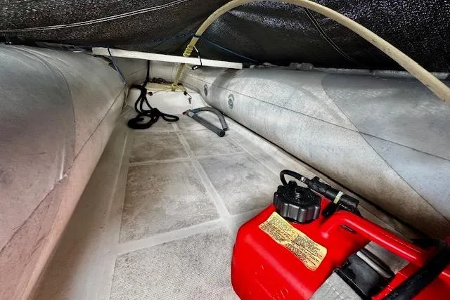 Slide: The Image of 2001 Silverton 42 Convertible boat interior with red fuel container and storage space. - 46