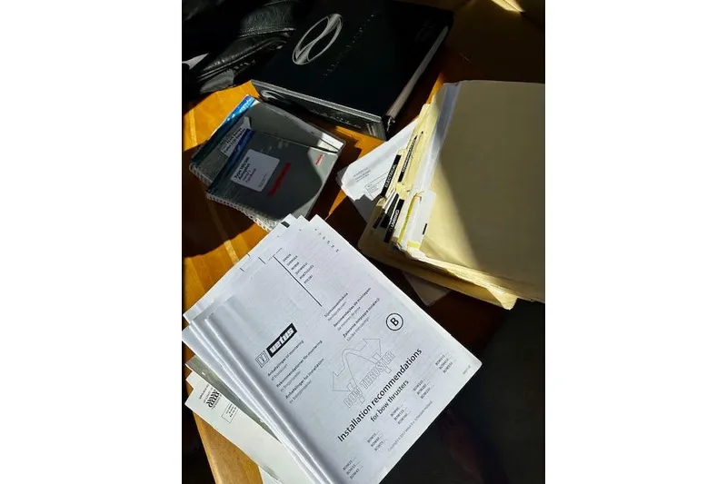 Slide: The Image of Documents and folders on a table, including installation recommendations for a 2001 Silverton 42 Convertible. - 47