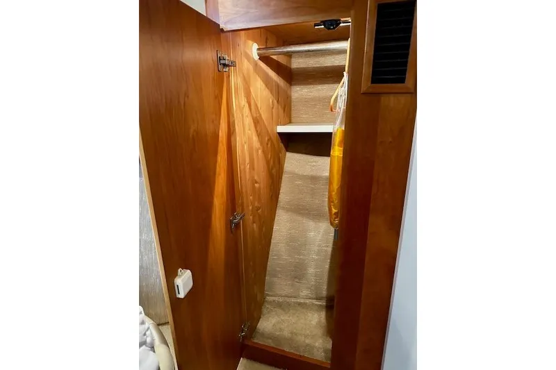 Slide: The Image of Wooden closet interior on a 2001 Silverton 42 Convertible yacht. - 7