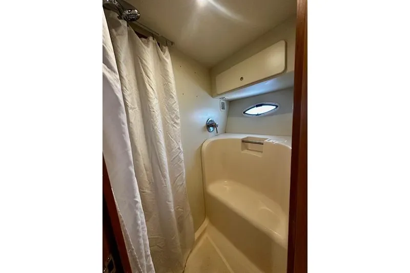 Slide: The Image of Shower area in 2001 Silverton 42 Convertible yacht with curtain and porthole window. - 8