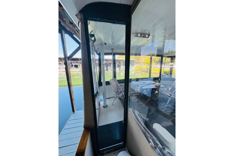 Slide: The Image of 1988 Sea Ray 415 Aft Cabin yacht with enclosed deck and marina view. - 12