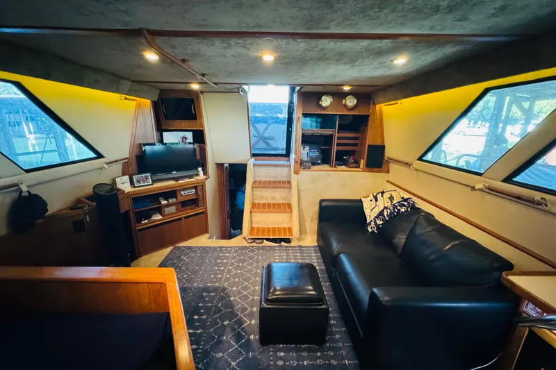 Slide: The Image of Interior of 1988 Sea Ray 415 Aft Cabin with cozy seating and entertainment area. - 23