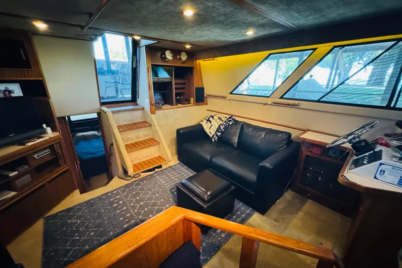 Slide: The Image of 1988 Sea Ray 415 Aft Cabin interior with cozy seating and nautical decor. - 24