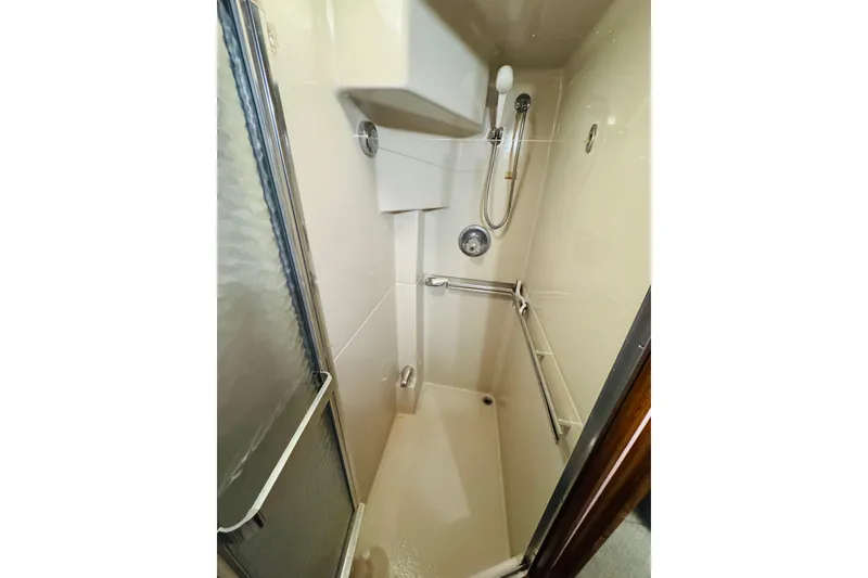 Slide: The Image of Shower area in 1988 Sea Ray 415 Aft Cabin yacht, featuring a sliding glass door. - 37