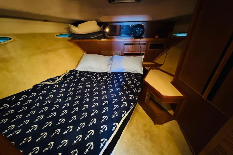 Slide: The Image of Cozy cabin interior of 1988 Sea Ray 415 Aft Cabin with nautical-themed bedding. - 38