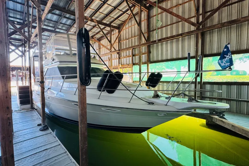 Slide: The Image of 1988 Sea Ray 415 Aft Cabin yacht docked in a covered marina. - 4