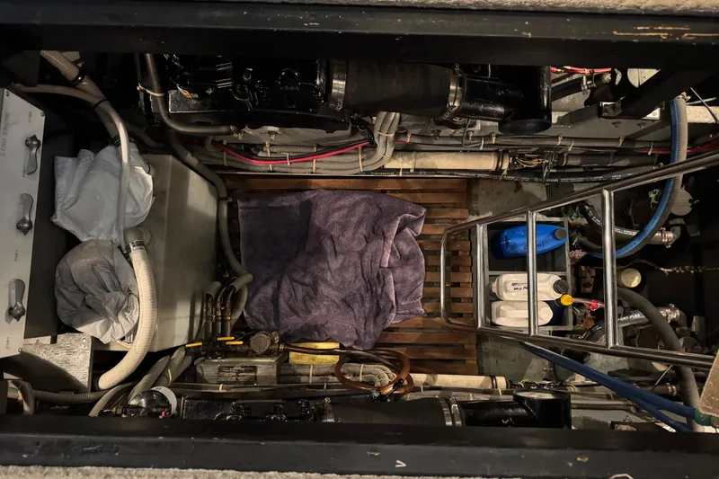 Slide: The Image of Engine room of 1988 Sea Ray 415 Aft Cabin with visible equipment and storage. - 41