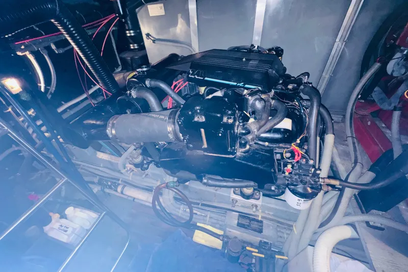 Slide: The Image of Engine room of 1988 Sea Ray 415 Aft Cabin with visible machinery and components. - 42