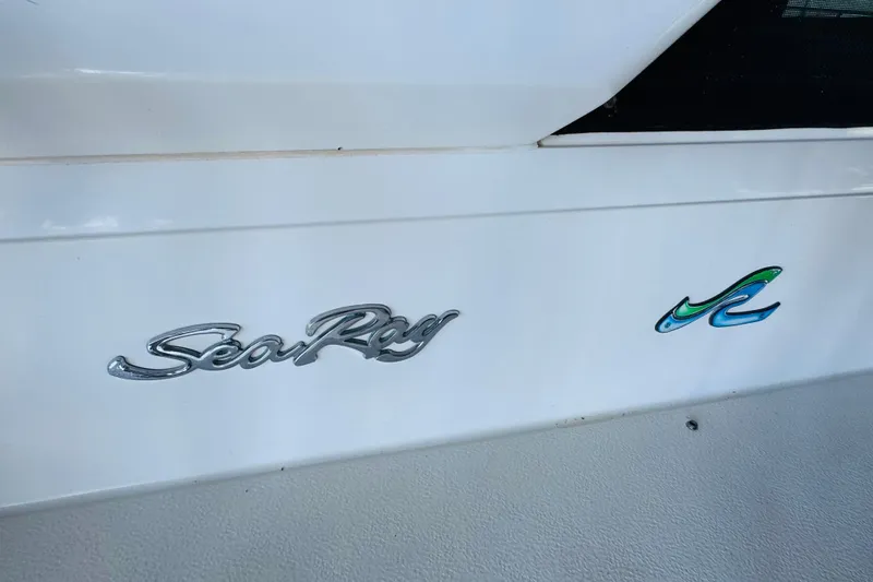Slide: The Image of Sea Ray 415 Aft Cabin 1988 logo on white boat surface. - 48