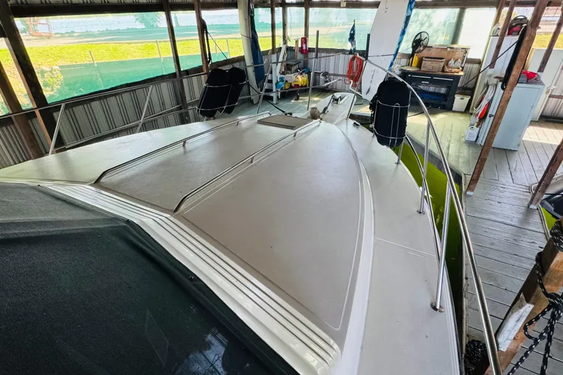 Slide: The Image of 1988 Sea Ray 415 Aft Cabin boat docked in a covered marina. - 8