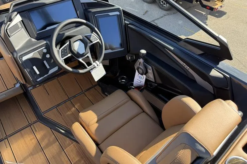 Slide: The Image of 2025 Supra SE 575 boat interior with modern dashboard and tan leather seating. - 10