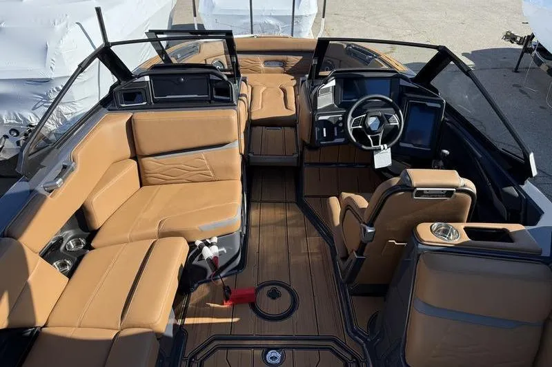 Slide: The Image of Luxurious interior of 2025 Supra SE 575 boat with tan leather seating and modern dashboard. - 6