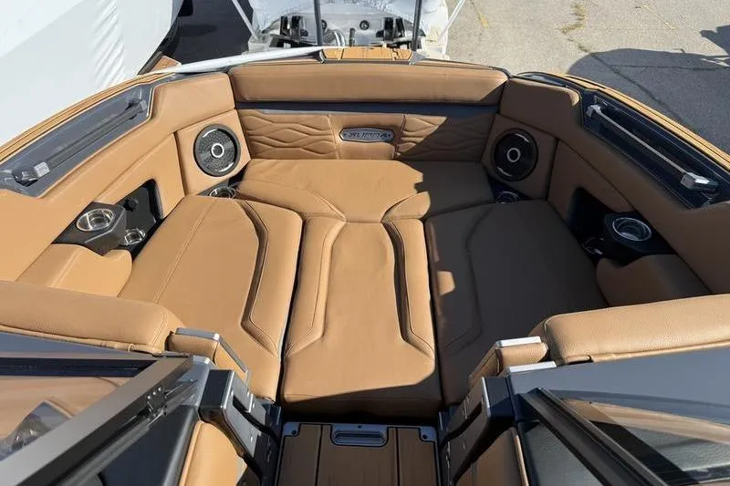 Slide: The Image of Luxurious interior of 2025 Supra SE 575 boat with tan leather seating and speakers. - 8