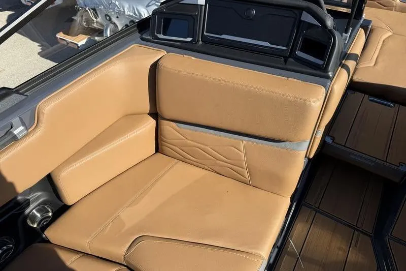 Slide: The Image of 2025 Supra SE 575 boat interior with tan leather seating and modern design. - 9