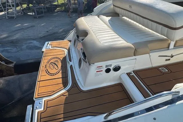 Slide: The Image of 2015 Cobalt 26SD boat with cushioned seating and teak-style deck. - 12