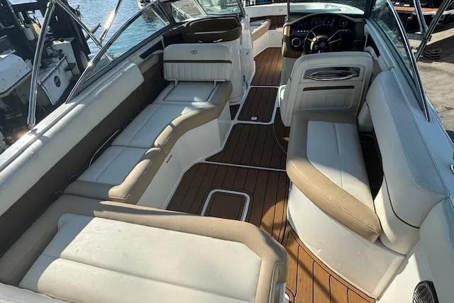 Slide: The Image of 2015 Cobalt 26SD boat interior with luxurious seating and wood flooring. - 14