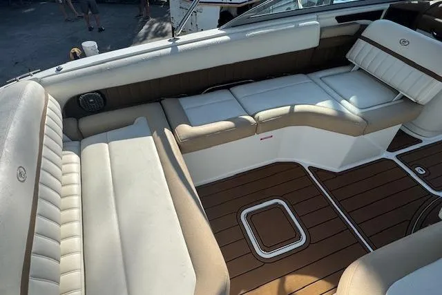 Slide: The Image of 2015 Cobalt 26SD boat interior with beige seating and wood-style flooring. - 15