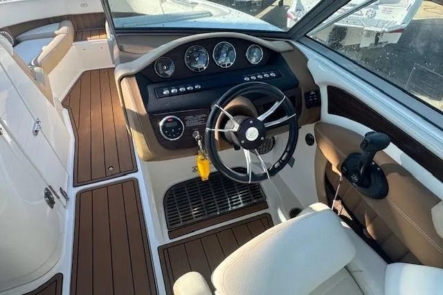Slide: The Image of 2015 Cobalt 26SD boat interior with steering wheel and dashboard controls. - 17