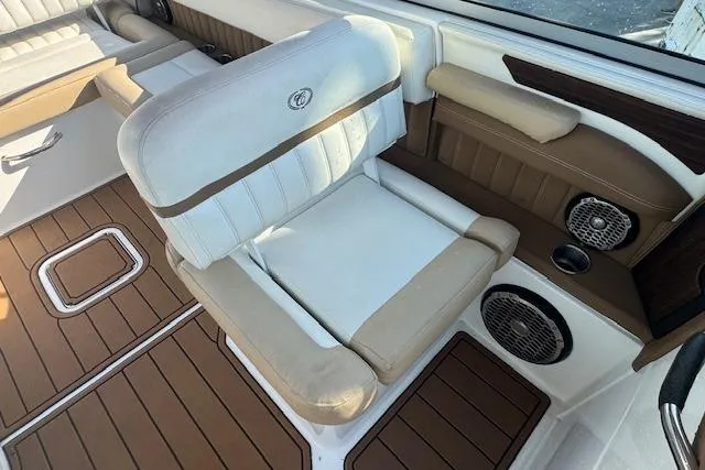 Slide: The Image of 2015 Cobalt 26SD boat interior with cushioned seating and wood accents. - 19