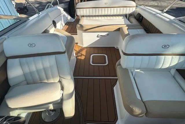 Slide: The Image of 2015 Cobalt 26SD boat interior with white and tan seating, teak flooring. - 20