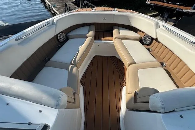Slide: The Image of 2015 Cobalt 26SD boat interior with spacious seating and elegant wood flooring. - 21