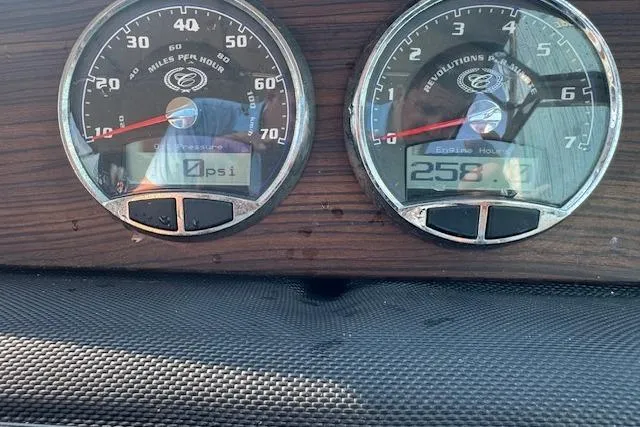 Slide: The Image of Dashboard gauges of a 2015 Cobalt 26SD boat showing speed and engine hours. - 24