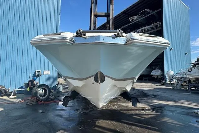 Slide: The Image of 2015 Cobalt 26SD boat in dry dock, front view, blue and white hull. - 4