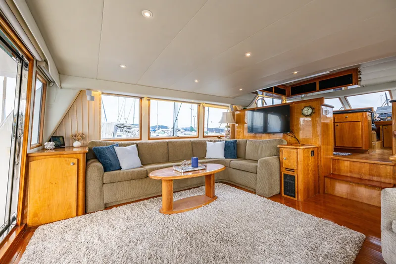 Slide: The Image of Luxurious interior of 2001 Navigator 61' Pilothouse yacht with plush seating and elegant wood finishes. - 37