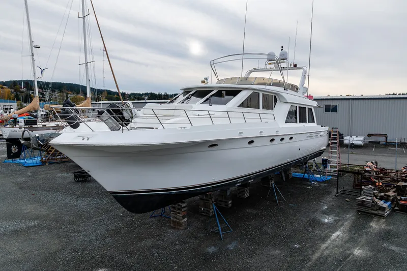 Slide: The Image of 2001 Navigator 61' Pilothouse yacht on dry dock, surrounded by marina setting. - 39