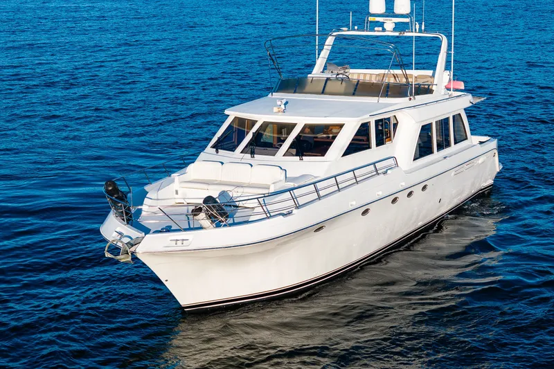 Slide: The Image of 2001 Navigator 61' Pilothouse yacht cruising on open blue water. - 22