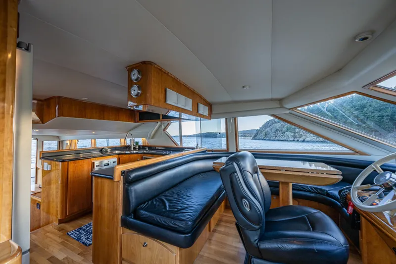 Slide: The Image of Luxurious 2001 Navigator 61' Pilothouse interior with leather seating and scenic ocean view. - 27