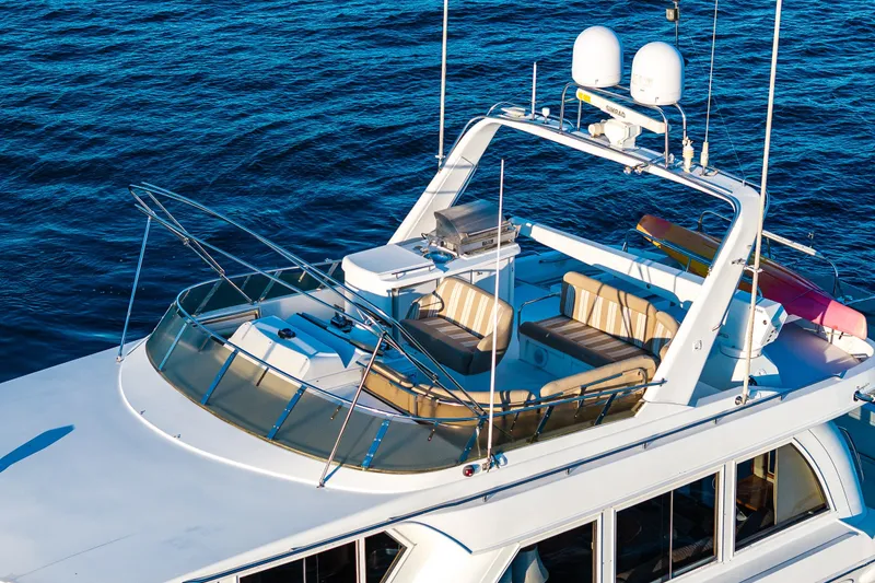 Slide: The Image of Luxurious 2001 Navigator 61' Pilothouse yacht with spacious deck and seating, cruising on blue waters. - 21