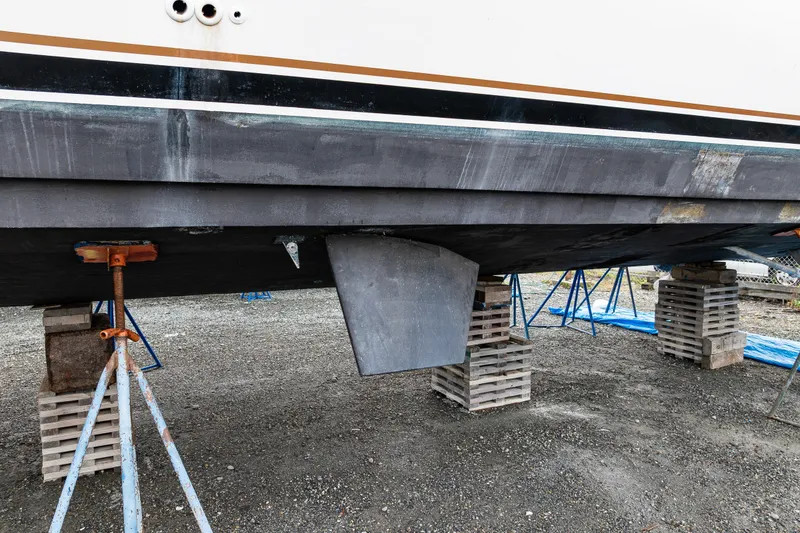 Slide: The Image of 2001 Navigator 61' Pilothouse yacht hull on blocks, under maintenance. - 40