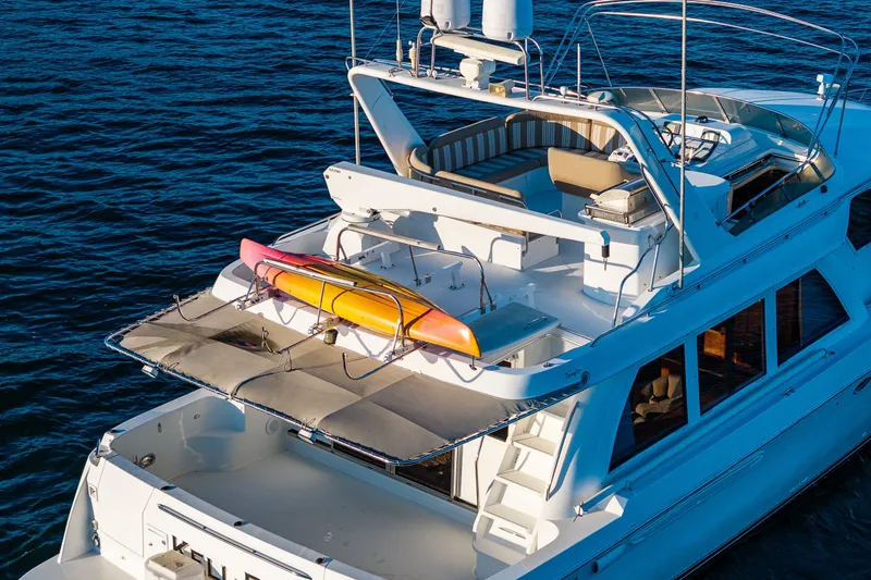 Slide: The Image of 2001 Navigator 61' Pilothouse yacht with kayaks on deck, cruising on open water. - 17
